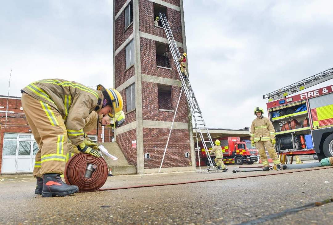 Learning how to curl up a fire hose at a Beds Fire Open Day. Image: Bedfordshire Fire and Rescue Service